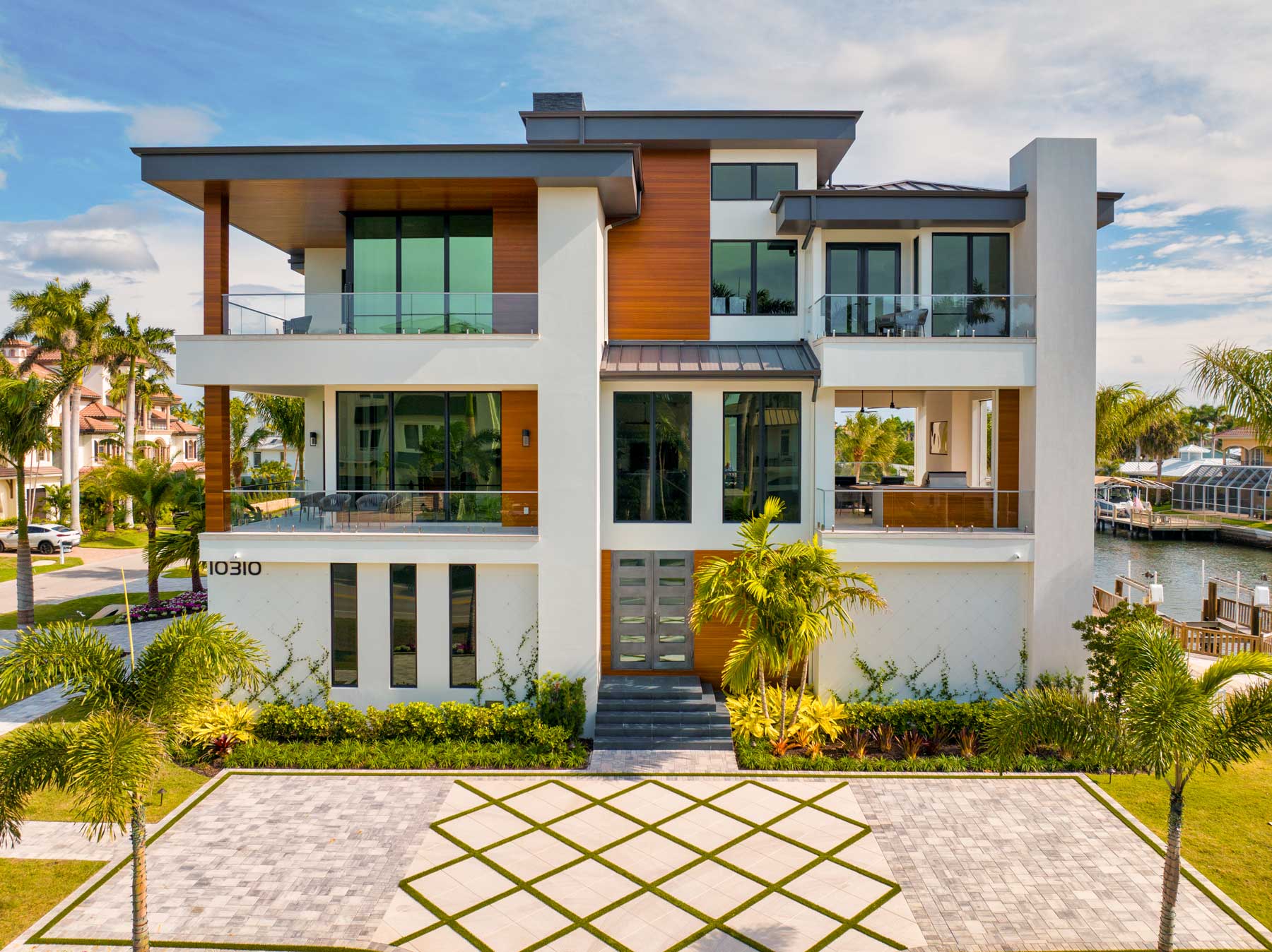 The front view of Diamond Custom Homes’ newly completed estate on the corner of Seabreeze Avenue and Gulf Shore Drive.